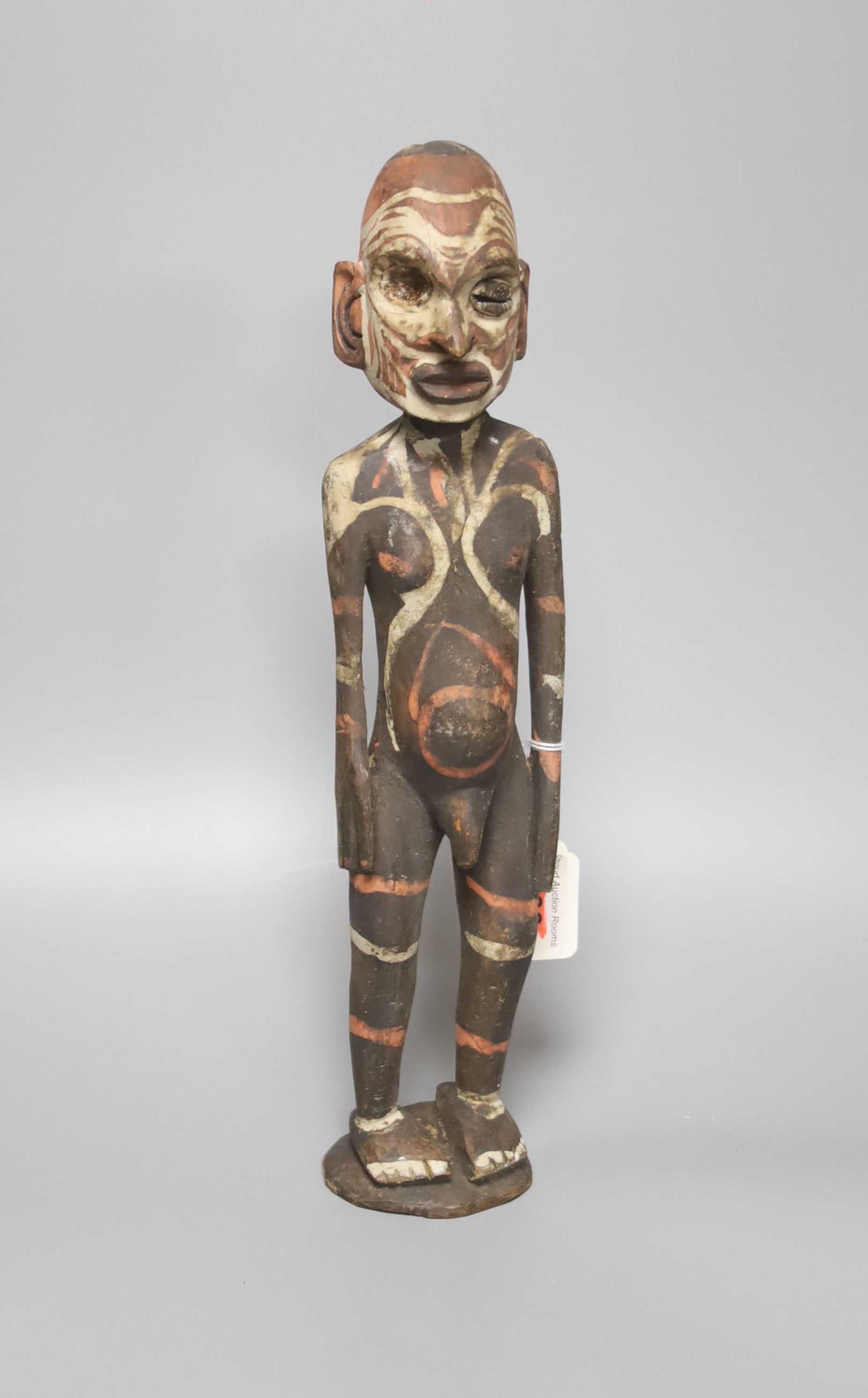 A Papua New Guinea wood figure, painted in coloured pigments, height 34cm